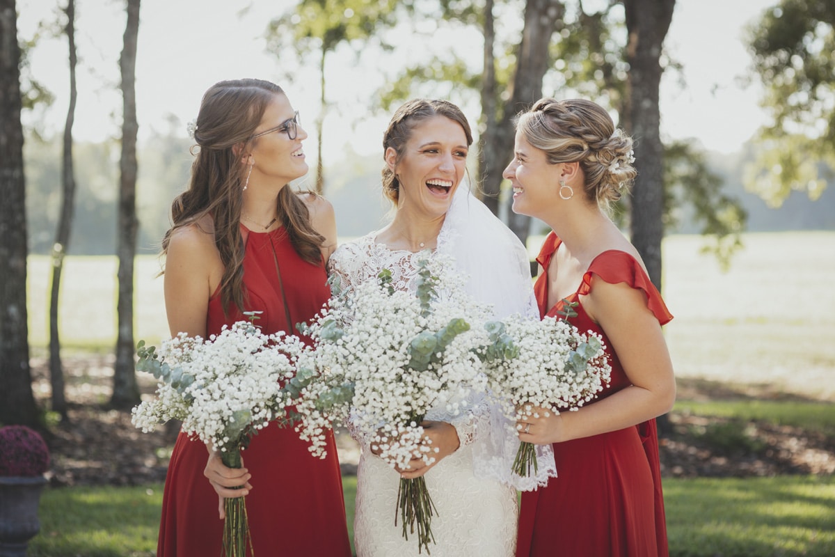 A bride and two bridesmaids laughing together