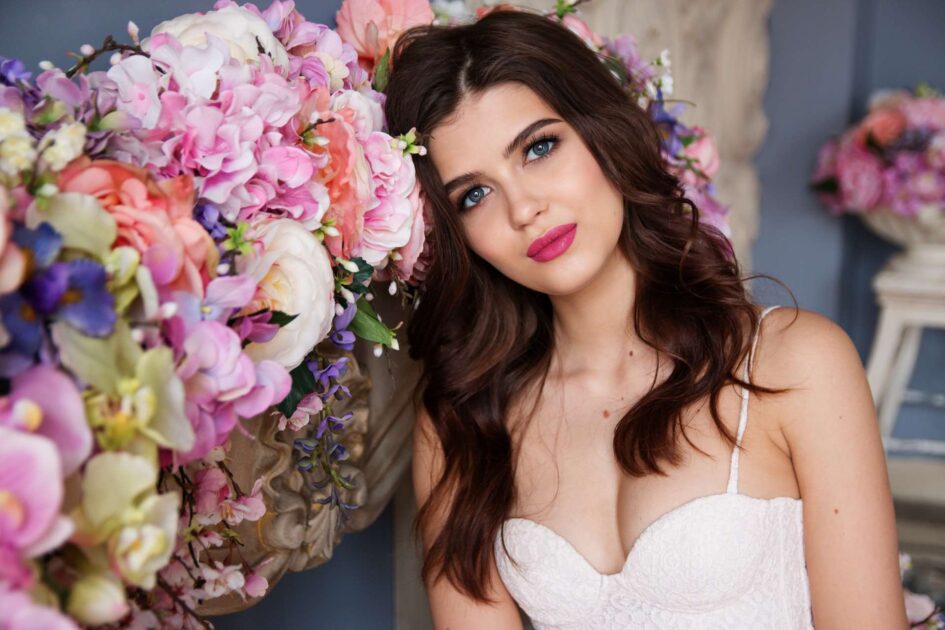 A bride resting her head against flowers